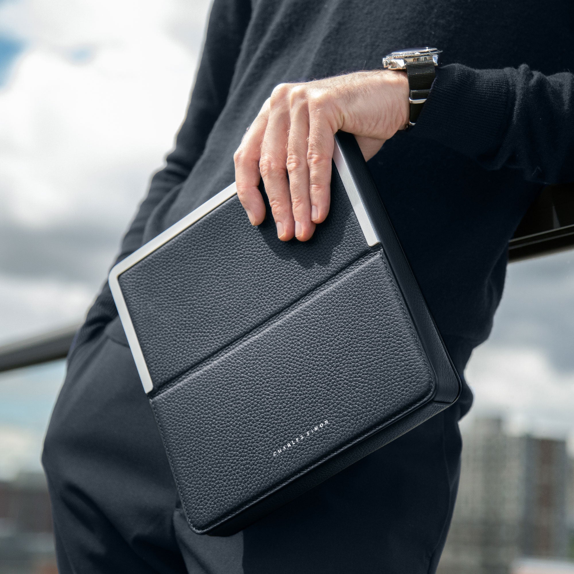 Lifestyle photo of man holding his minimalist Fraser Travel wallet